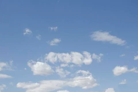 White clouds on a blue sky. Background. Stock Photos