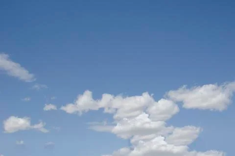 White clouds on a blue sky. Background. Stock Photos