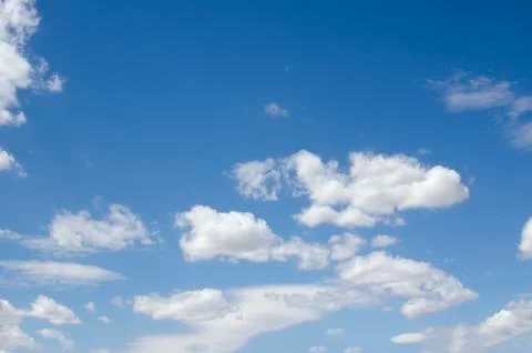 White clouds on a blue sky. Background. Stock Photos