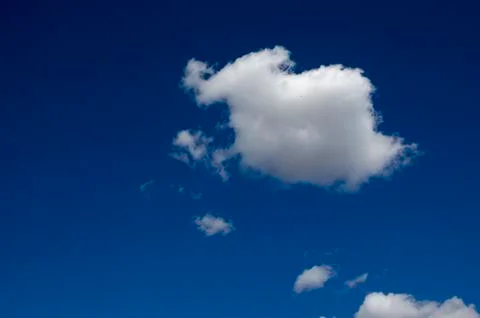 White clouds on a blue sky. Background. Stock Photos
