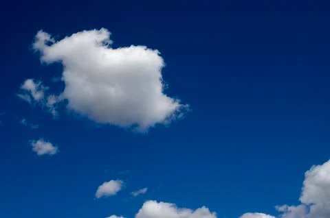 White clouds on a blue sky. Background. Stock Photos