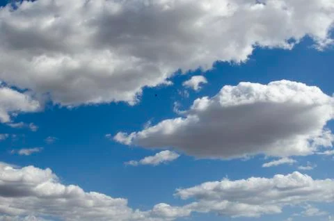 White clouds on a blue sky. Background. Stock Photos
