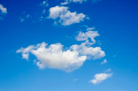 White clouds on a blue sky. Background. Stock Photos
