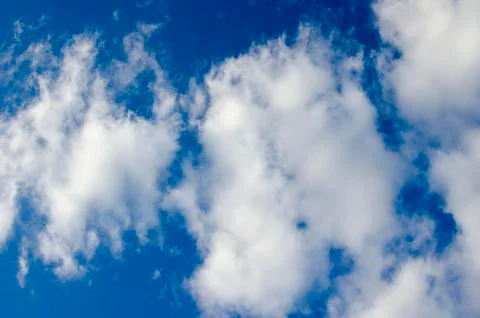 White clouds on a blue sky. Background. Stock Photos