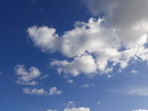 White clouds on a blue sky. Background. Stock Photos