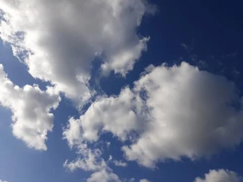 White clouds on a blue sky. Background. Stock Photos