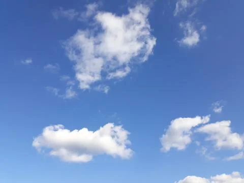 White clouds on a blue sky. Background. Stock Photos