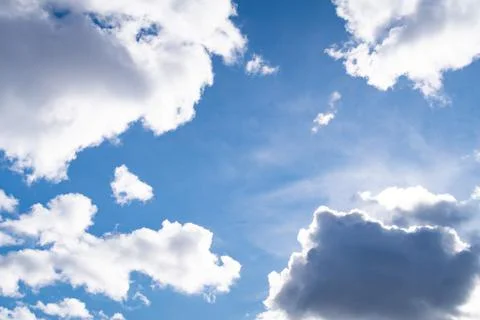 White clouds on blue sky background, sunlight, heavenly background Stock Photos