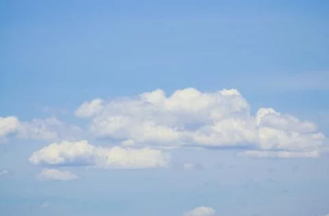 White clouds in the blue sky background and texture. Stock Photos