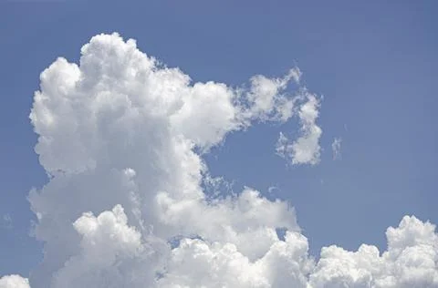 White clouds in the blue sky background and texture. Stock Photos