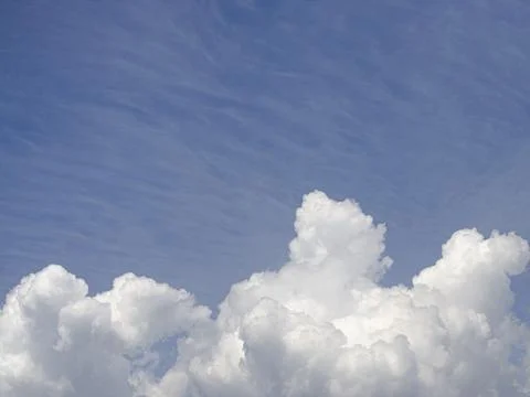 White clouds in the blue sky background and texture. Stock Photos