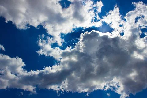 White clouds on a blue sky background. Clear weather. Summer morning Stock Photos