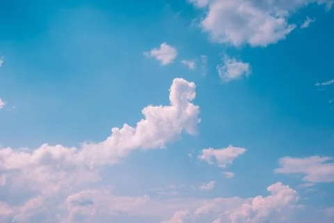 White clouds in blue sky with bright light background Stock Photos