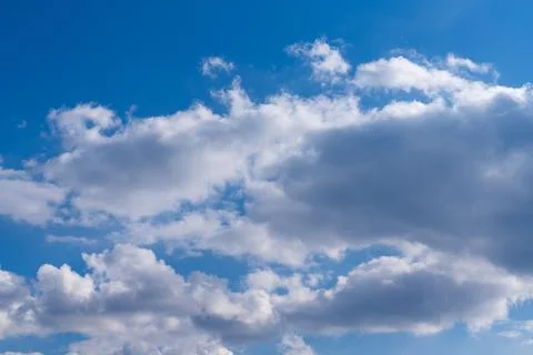 White clouds in the blue sky. Clear heaven on a clear, fine summer day Stock Photos