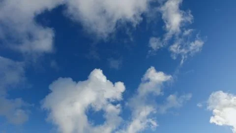 White clouds on a blue sky in cold winter day Stock Photos