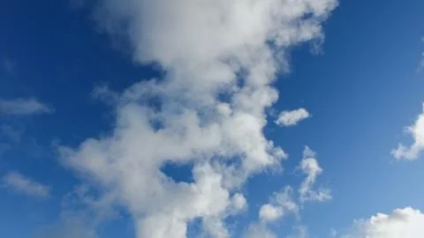 White clouds on a blue sky in cold winter day Stock Photos