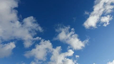 White clouds on a blue sky in cold winter day Stock Photos