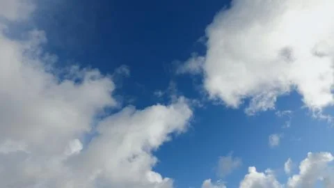 White clouds on a blue sky in cold winter day Stock Photos