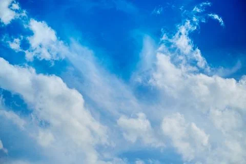White clouds in the blue sky, light on the clouds in the sky Stock Photos