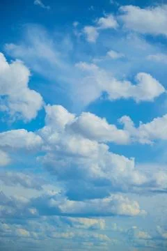 White clouds in the blue sky, light on the clouds in the sky Stock Photos
