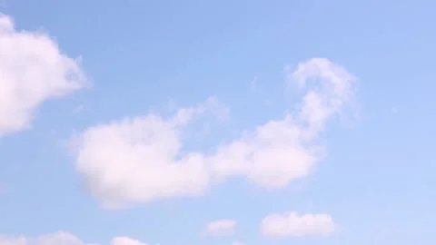 White clouds in the blue sky move slowly under the influence of the wind. Stock Footage 234202374