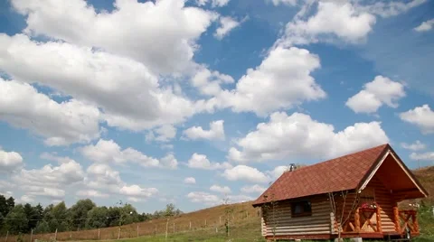 White clouds on the blue sky over the wooden house Stock-Footage 54727452