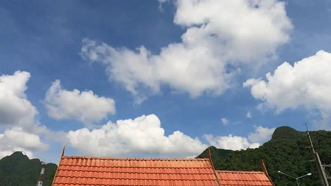 White clouds blue sky over Traditional Thai red orange roof top Video stock 156084860