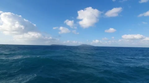 White clouds in the blue sky over the sea Vidéo 336414025