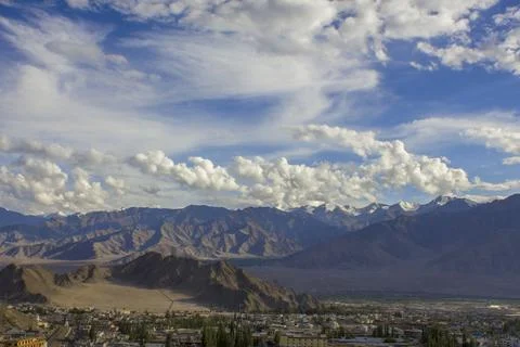 White clouds in the blue sky over the Himalayan mountains Stock Photos