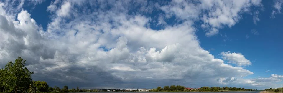 White Clouds On A Blue Sky Over The City Stock Photos