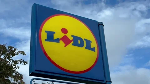White clouds in a blue sky passing behind a Lidl sign. Stock Footage 317516745