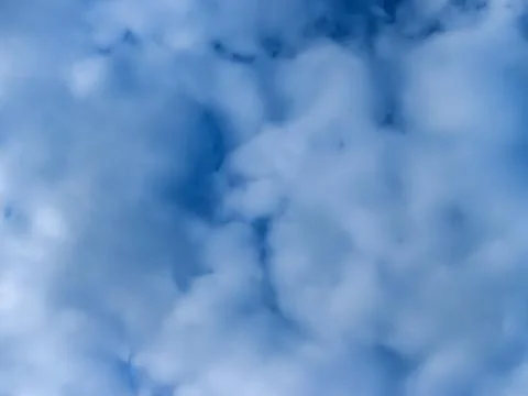 White clouds in the blue sky. Stock Photos