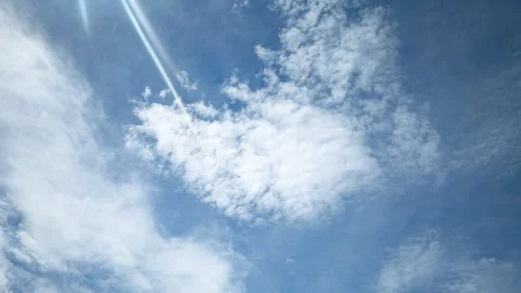 White Clouds in Blue Sky with Rays of Light (Timelapse, 60 Seconds) Stock Footage 315601152