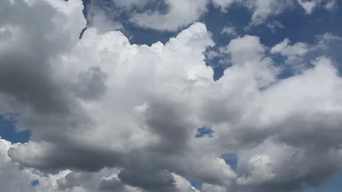 White clouds in the blue sky slowly move to follow Stock Footage 282627260