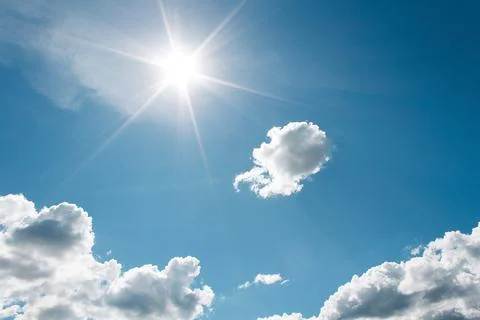 White Clouds on the blue sky with sun shines Stock Photos