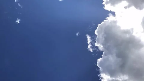White clouds on blue sky in time lapse with sun rays at the end, copy space Stock Footage 153983460