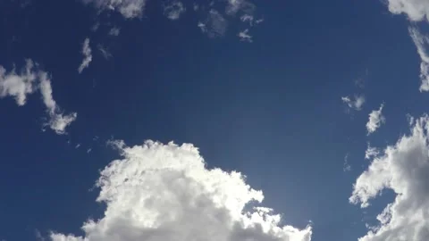 White clouds on blue sky in time lapse with sun rays, copy space Stock Footage 153987023