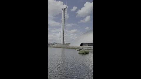 White clouds in a bright blue sky moving behind the Science Centre Tower. Stock Footage 336871371