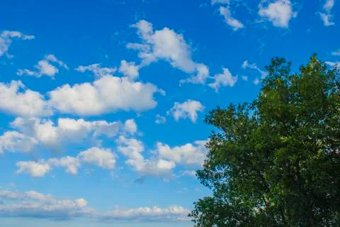 White clouds in bright blue sky Stock Photos