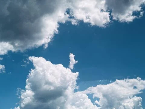 White Clouds on Bright Blue Sky Background. Stock Photos