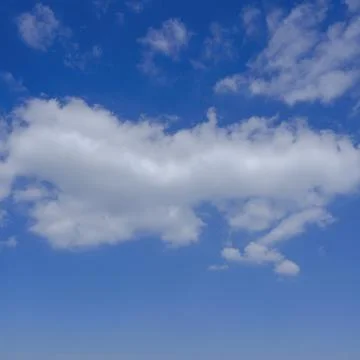 The white clouds on the clear blue sky Stock Photos