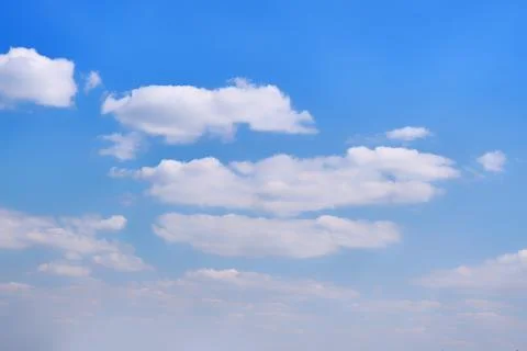 White clouds in clear spring weather. Sunny sky in the morning with floating  Stock Photos