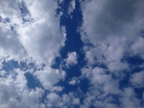 White clouds in a dark blue sky Stock Photos