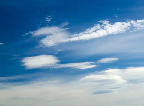 White clouds in deep blue summer sky Stock Photos