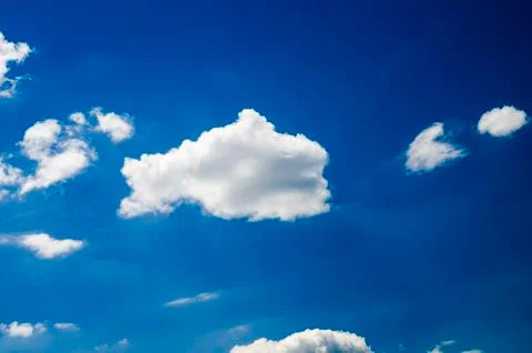 White clouds in deep blue summer sky Stock Photos