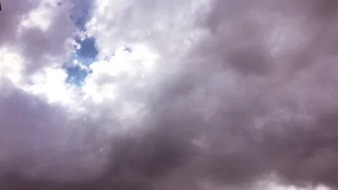 White clouds disappear in the hot sun on blue sky. Time-lapse motion clouds blue Stock Footage 76774096
