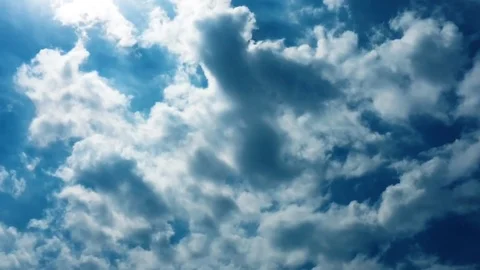 White clouds disappear in the hot sun on blue sky. Time-lapse motion clouds blue Stock Footage 76774554