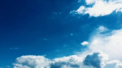 White clouds disappear in the hot sun on blue sky. Time-lapse motion clouds blue Stock Footage 76842614