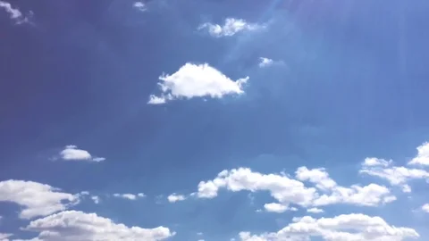 White clouds disappear in the hot sun on blue sky. Time-lapse motion clouds blue Stock Footage 76843072