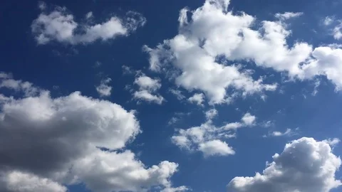 White clouds disappear in the hot sun on blue sky. Time-lapse motion clouds blue Stock Footage 76843149
